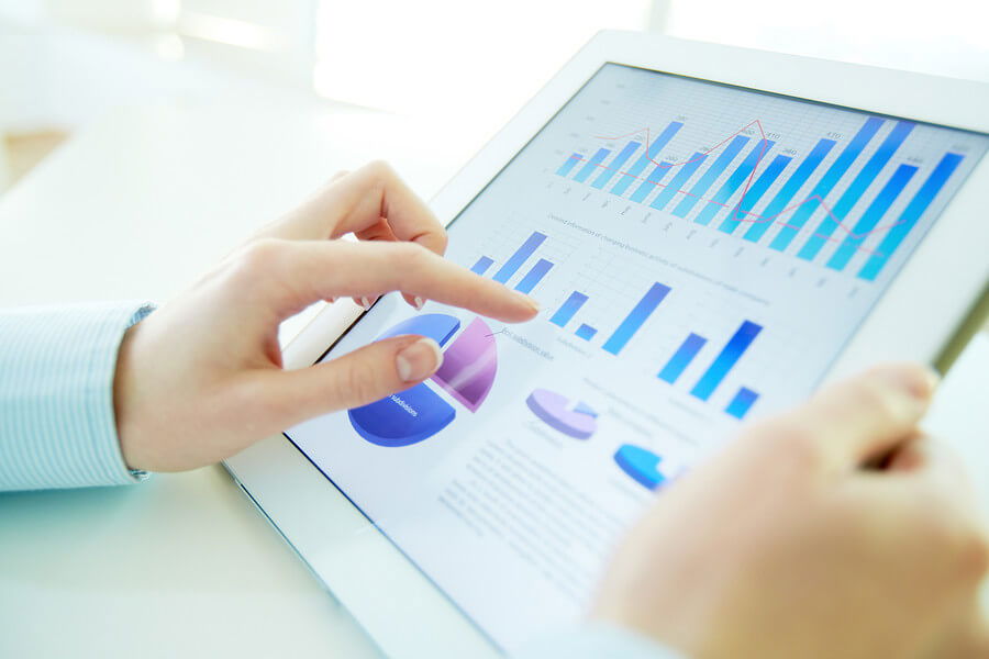 Close-up image of an office worker using a touchpad to analyze s