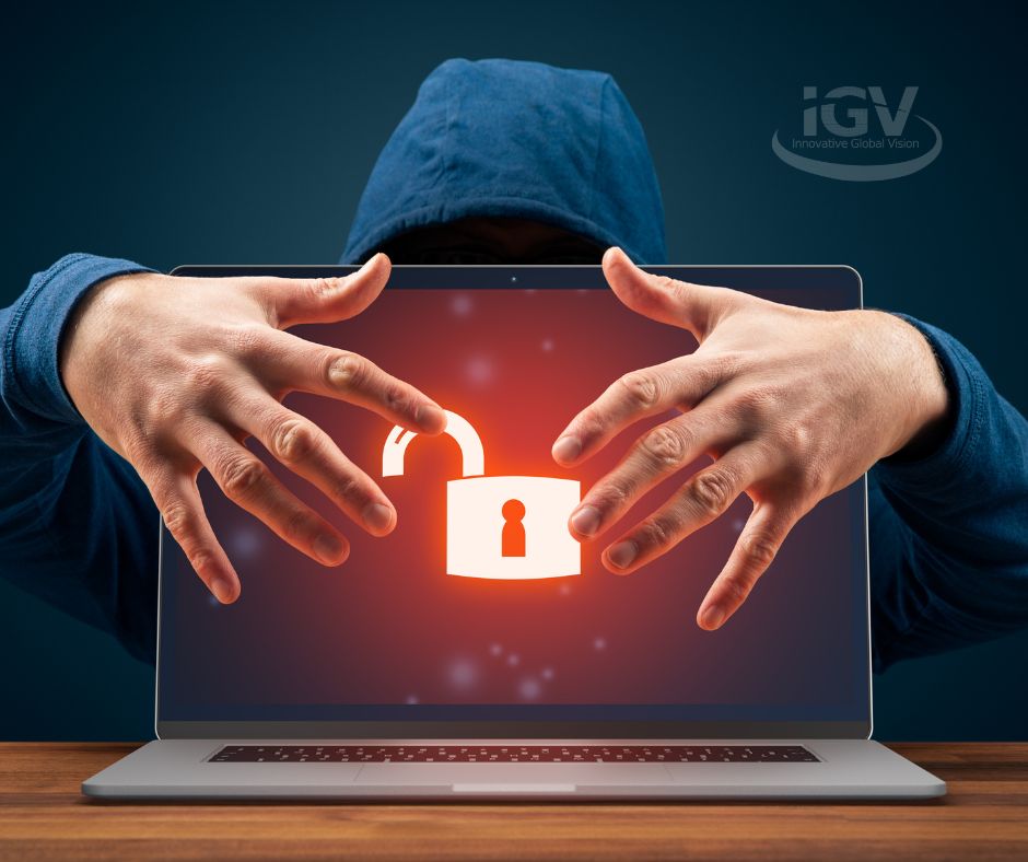 hooded person sitting behind a computer with both hands reaching around the back. red unlocked lock on computer screen. IGV log top right